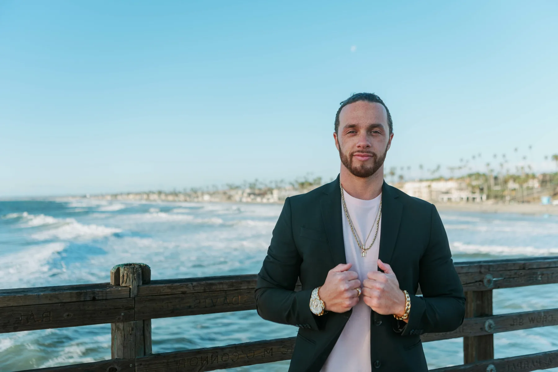 Rudy Perez Jr. standing on a pier in a black blazer